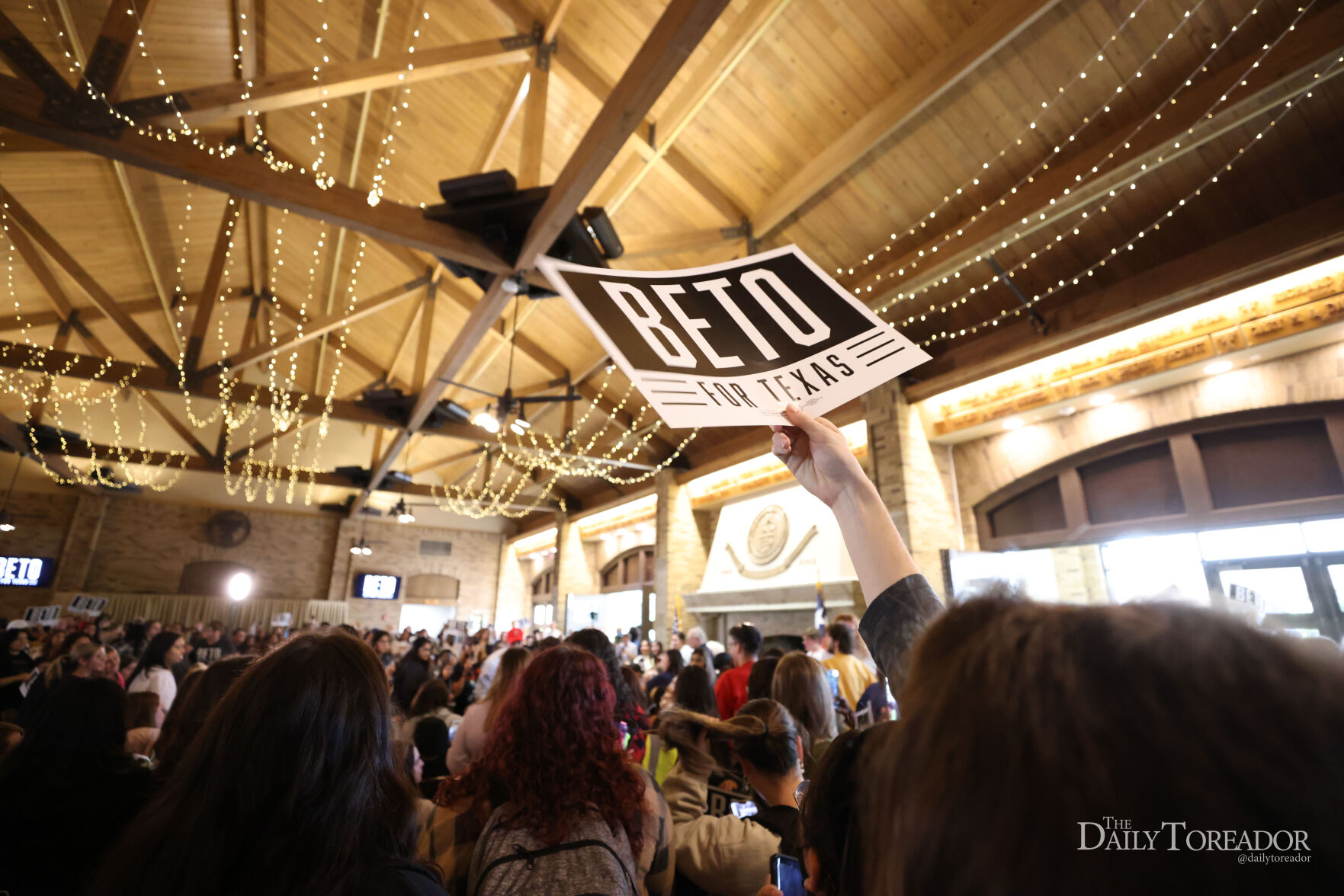 Campaign attendee raising sign